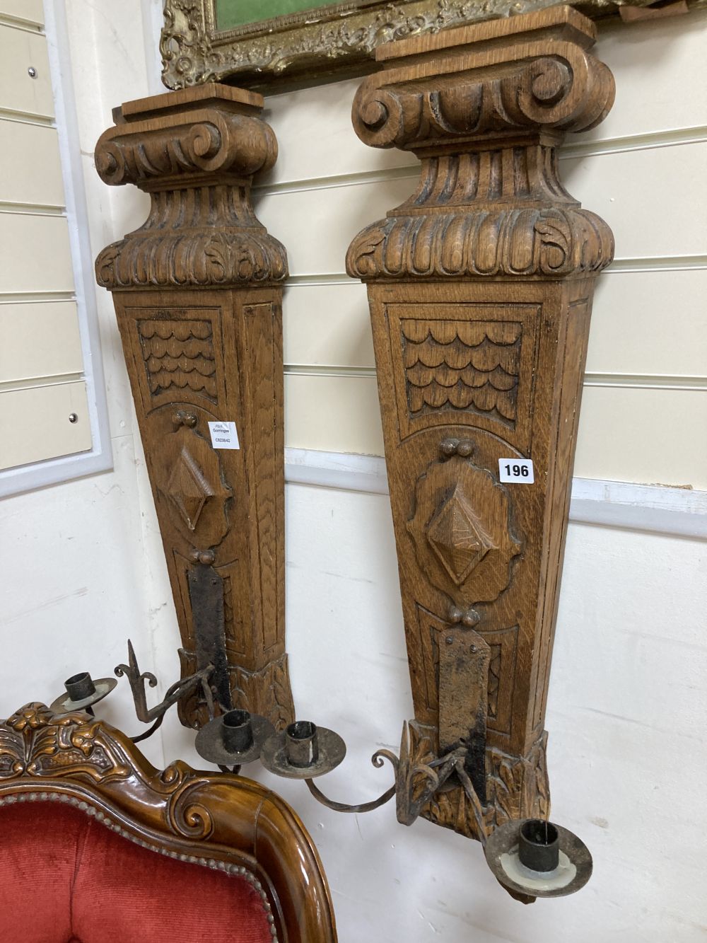 A pair of oak and iron wall sconces, height 88cm